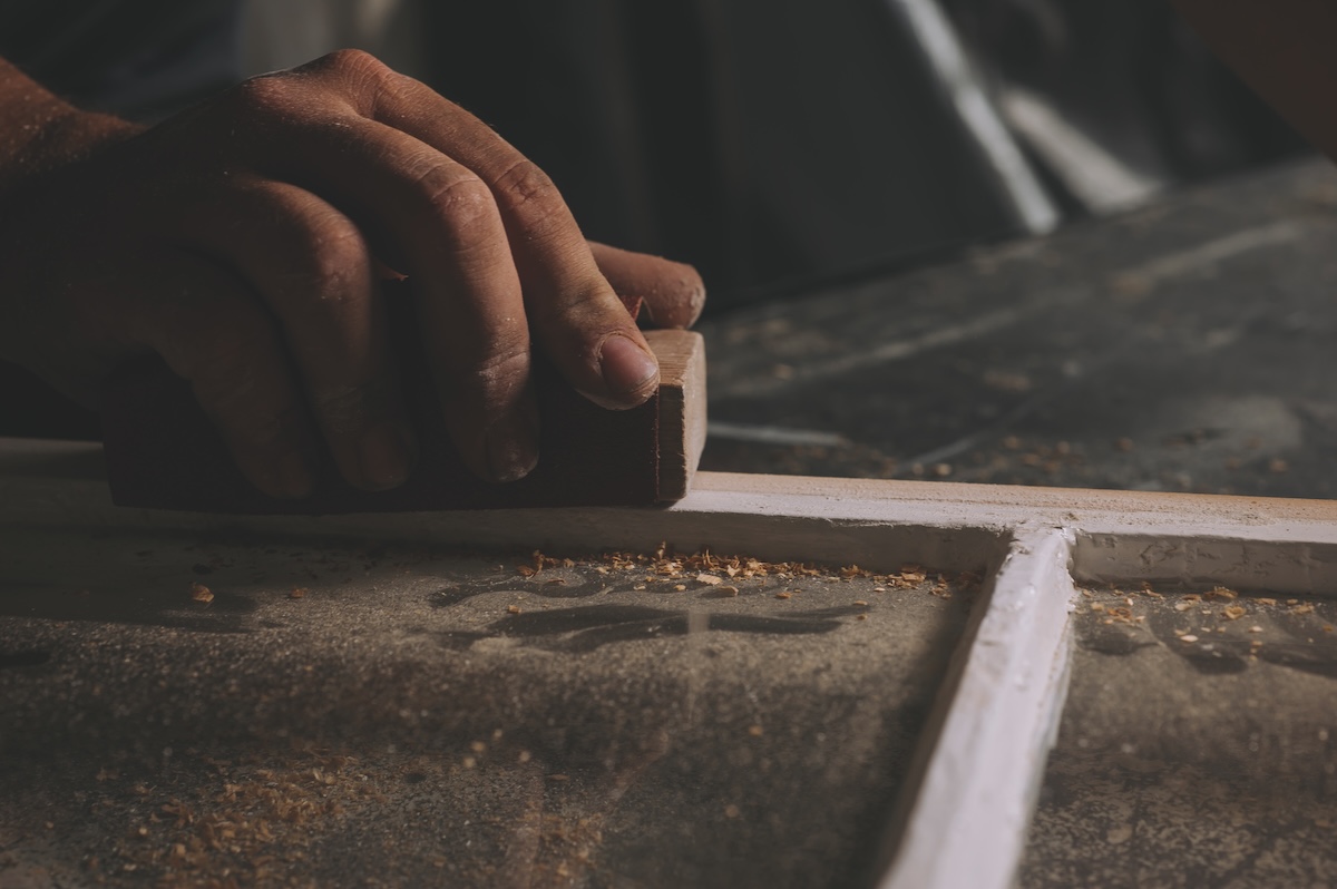 craftspeople filing a window frame